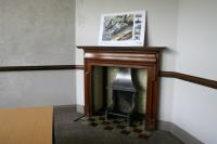 Close up view of original wooden fireplace in the General Colliery Managers Office.